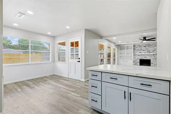 a view of kitchen with granite countertop cabinets and window