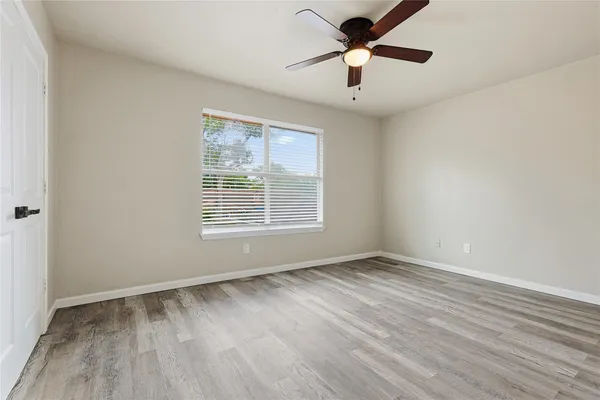 wooden floor in an empty room with a window