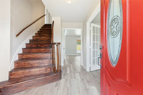 a view of an entryway with wooden floor