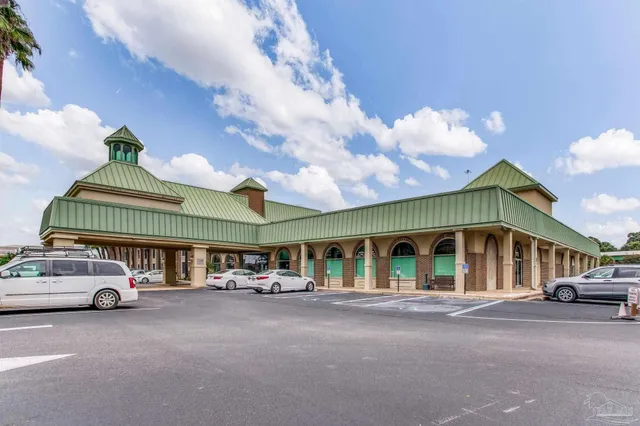 a couple of cars parked in front of building