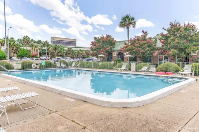a view of a swimming pool with a yard