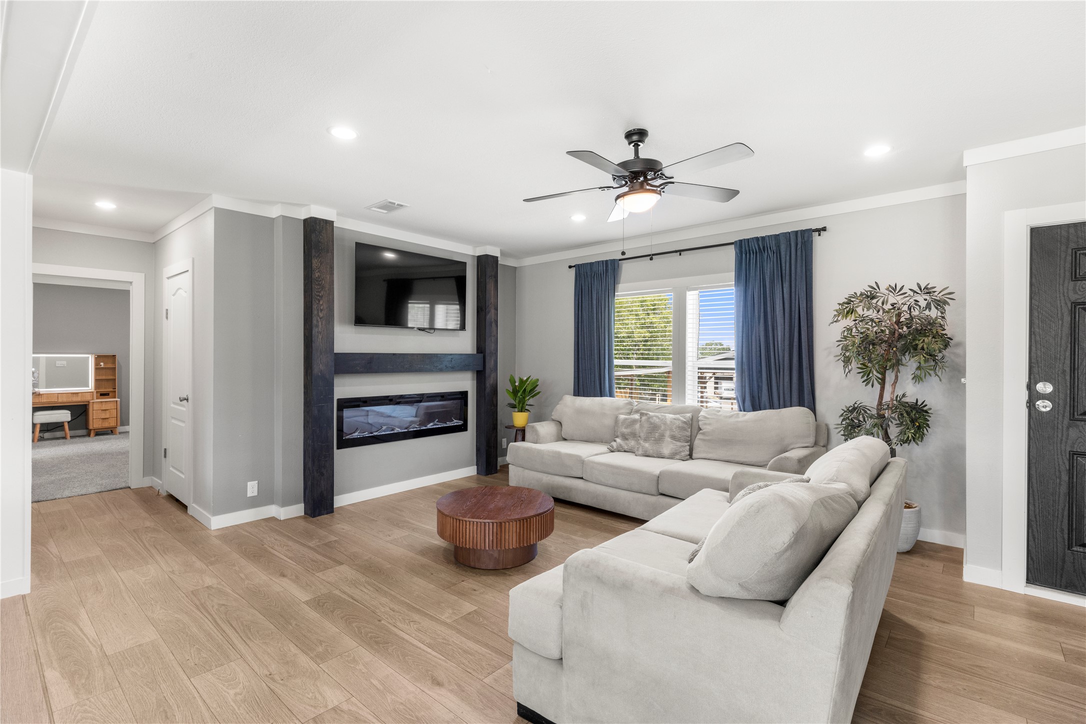 201 Greenfield Road Kyle, TX 78640 - Photo 23 of 28 A refined living area showcases an inviting fireplace and lustrous wood flooring.