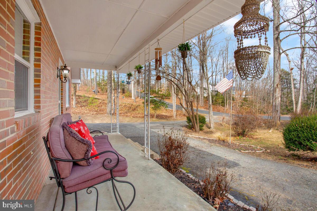 391 Red Cloud Road Lusby, MD 20657 - Photo 3 of 39 Cozy quiet front porch with garden area.