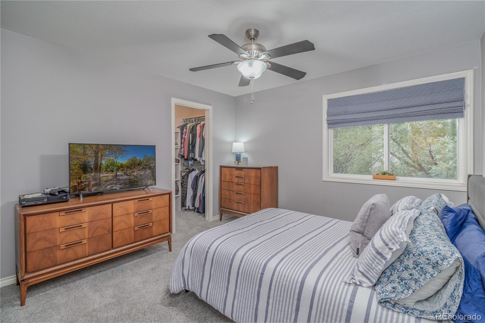 3940 Montclair Lane Boulder, CO 80301 - Photo 18 of 26 a bedroom with a bed and a flat screen tv