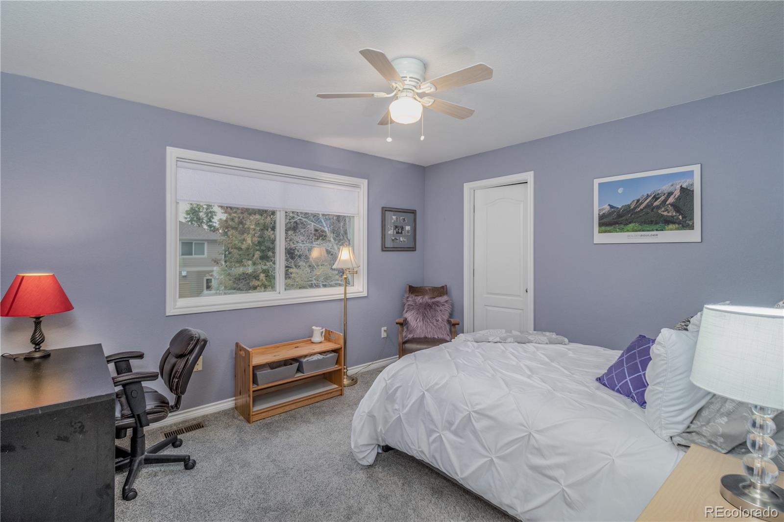 3940 Montclair Lane Boulder, CO 80301 - Photo 20 of 26 a bedroom with a bed and a chandelier