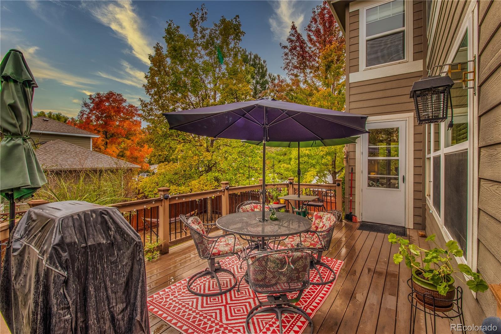 3940 Montclair Lane Boulder, CO 80301 - Photo 23 of 26 a view of a patio with table and chairs under an umbrella with wooden floor