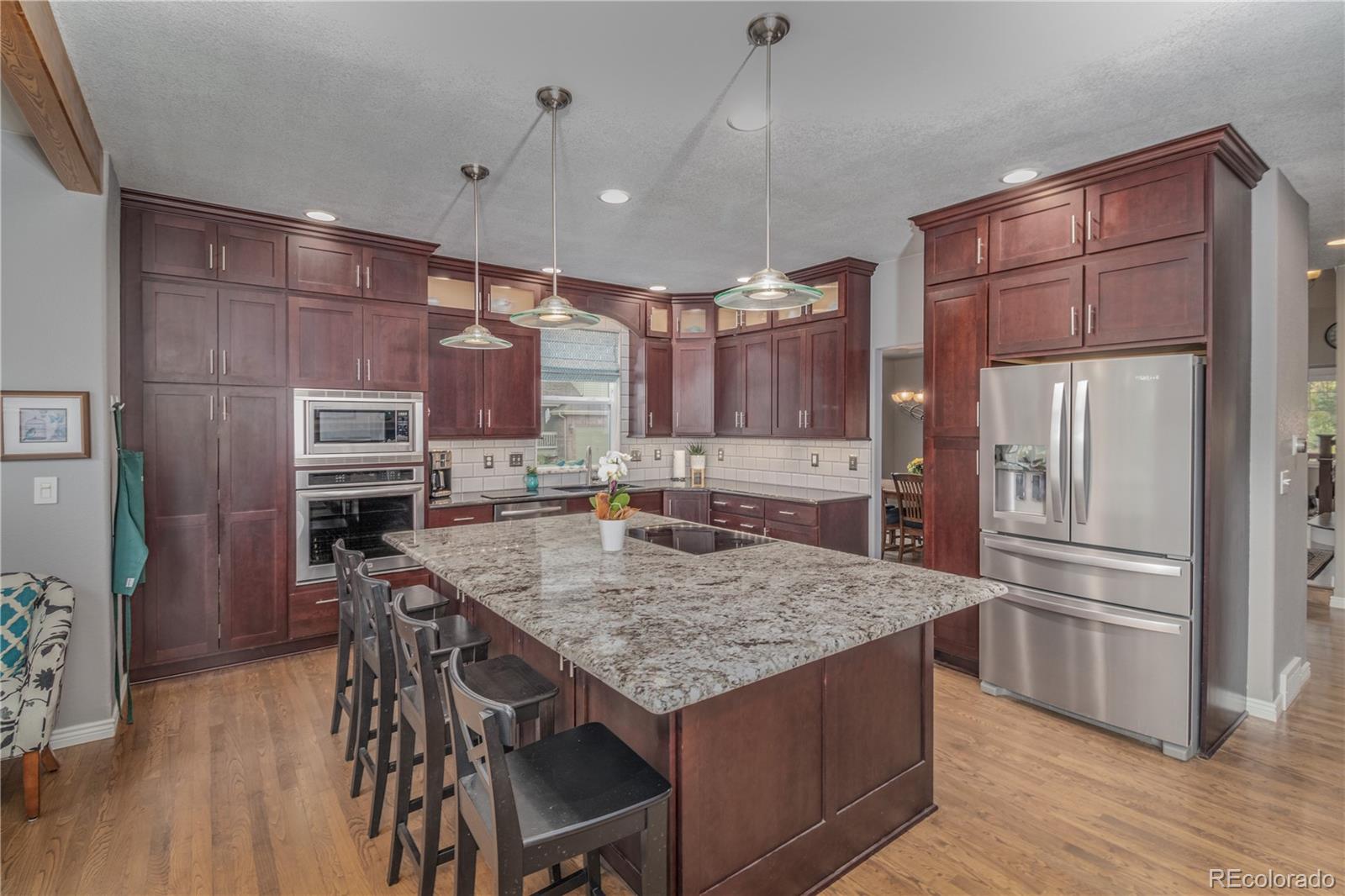 3940 Montclair Lane Boulder, CO 80301 - Photo 5 of 26 a kitchen with a table chairs refrigerator and microwave