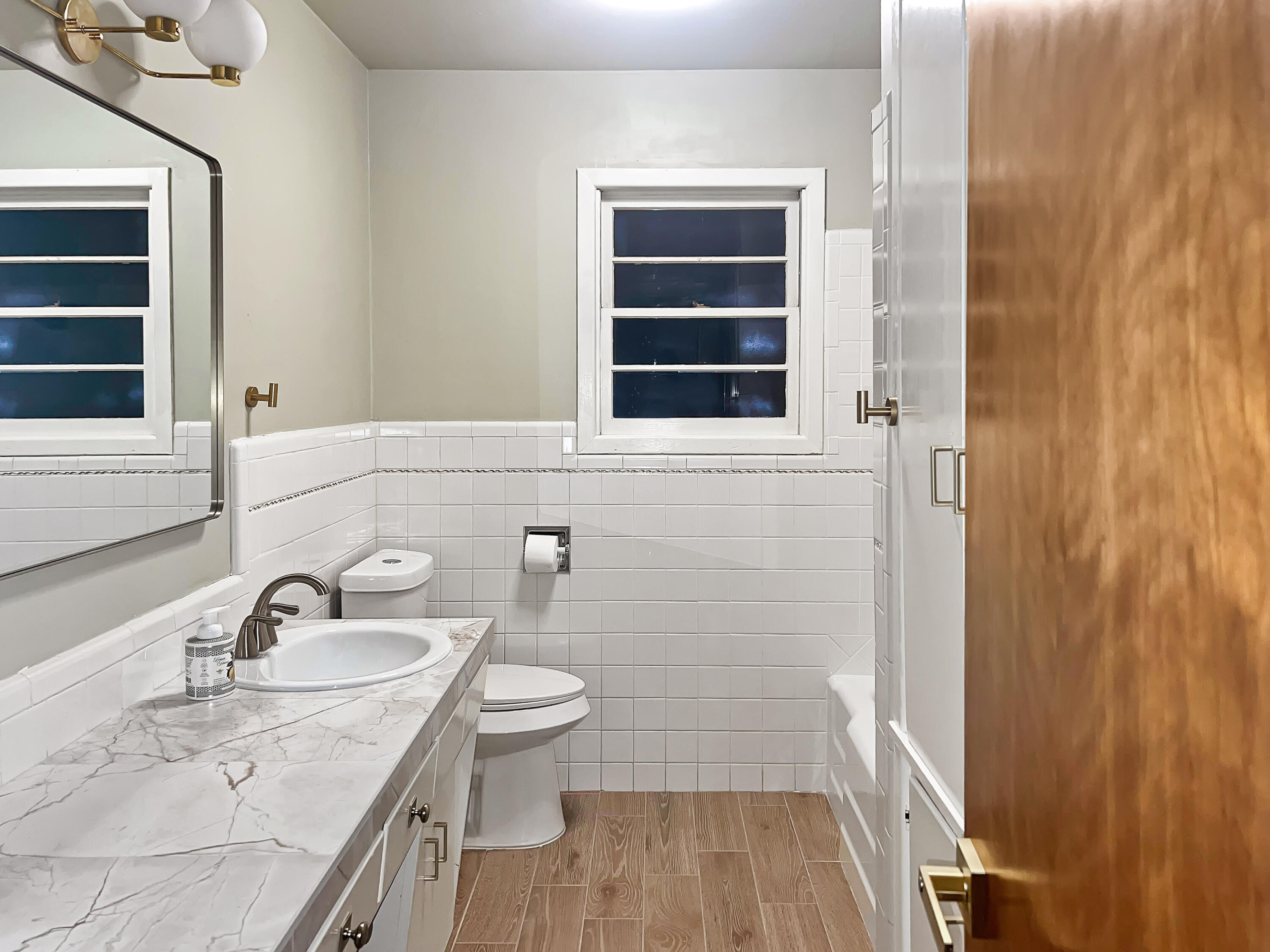 3827 52nd Street Lubbock, TX 79413 - Photo 12 of 24 a bathroom with a sink and a mirror