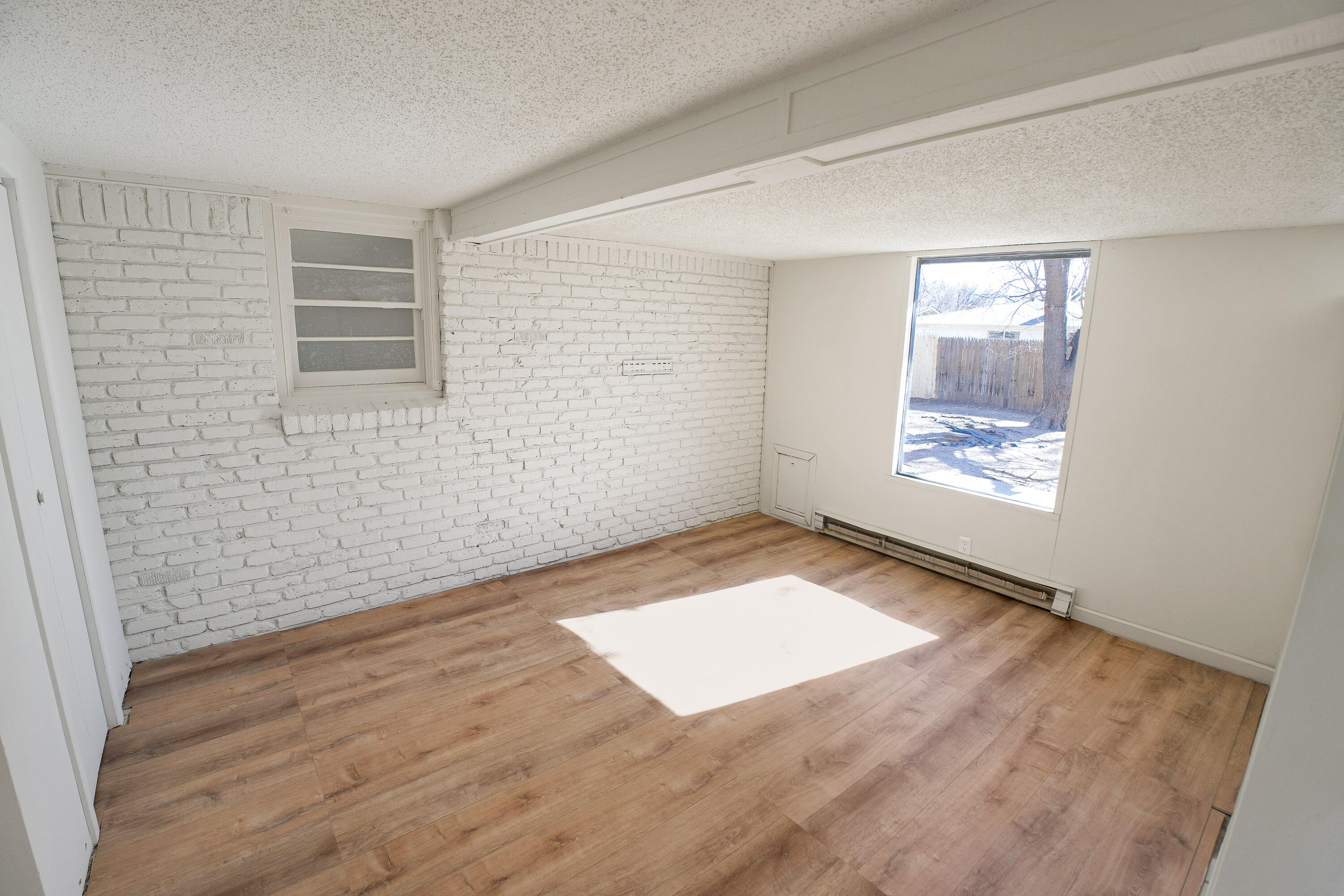 3827 52nd Street Lubbock, TX 79413 - Photo 20 of 24 an empty room with wooden floor and windows