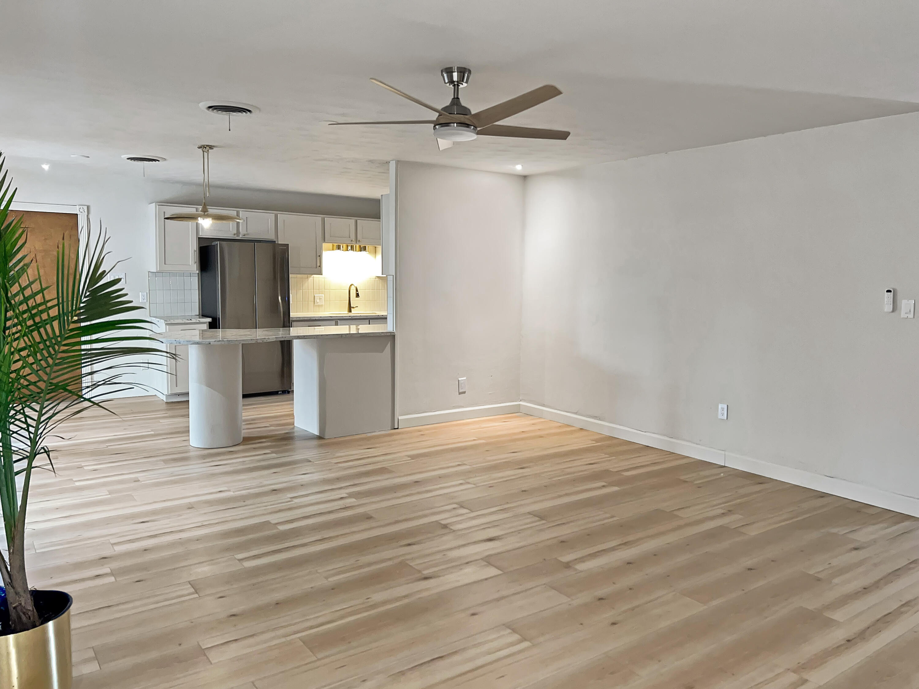 3827 52nd Street Lubbock, TX 79413 - Photo 22 of 24 an empty room with wooden floor a ceiling fan and windows