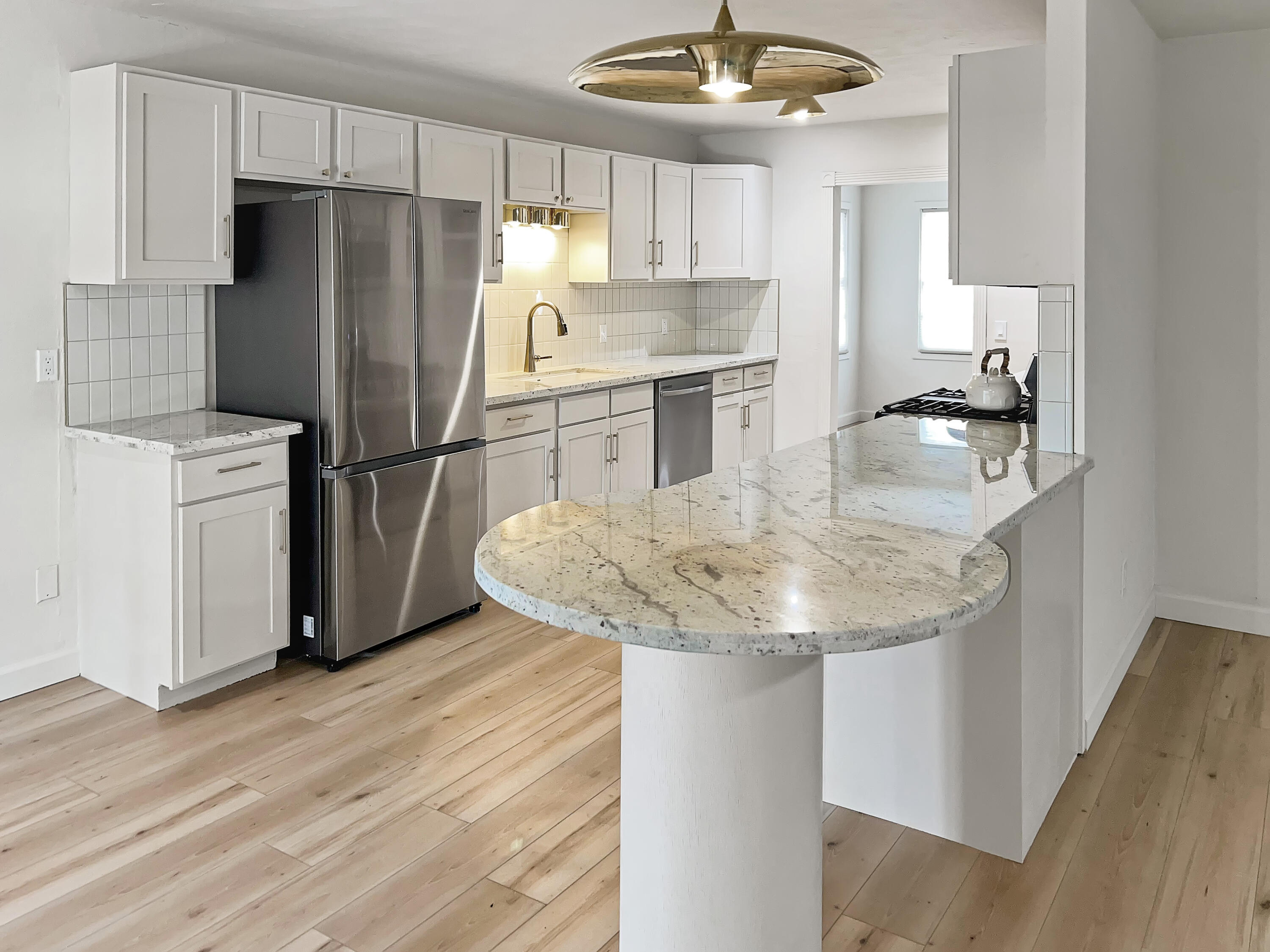 3827 52nd Street Lubbock, TX 79413 - Photo 5 of 24 a kitchen with stainless steel appliances granite countertop a refrigerator a sink a stove a microwave and island