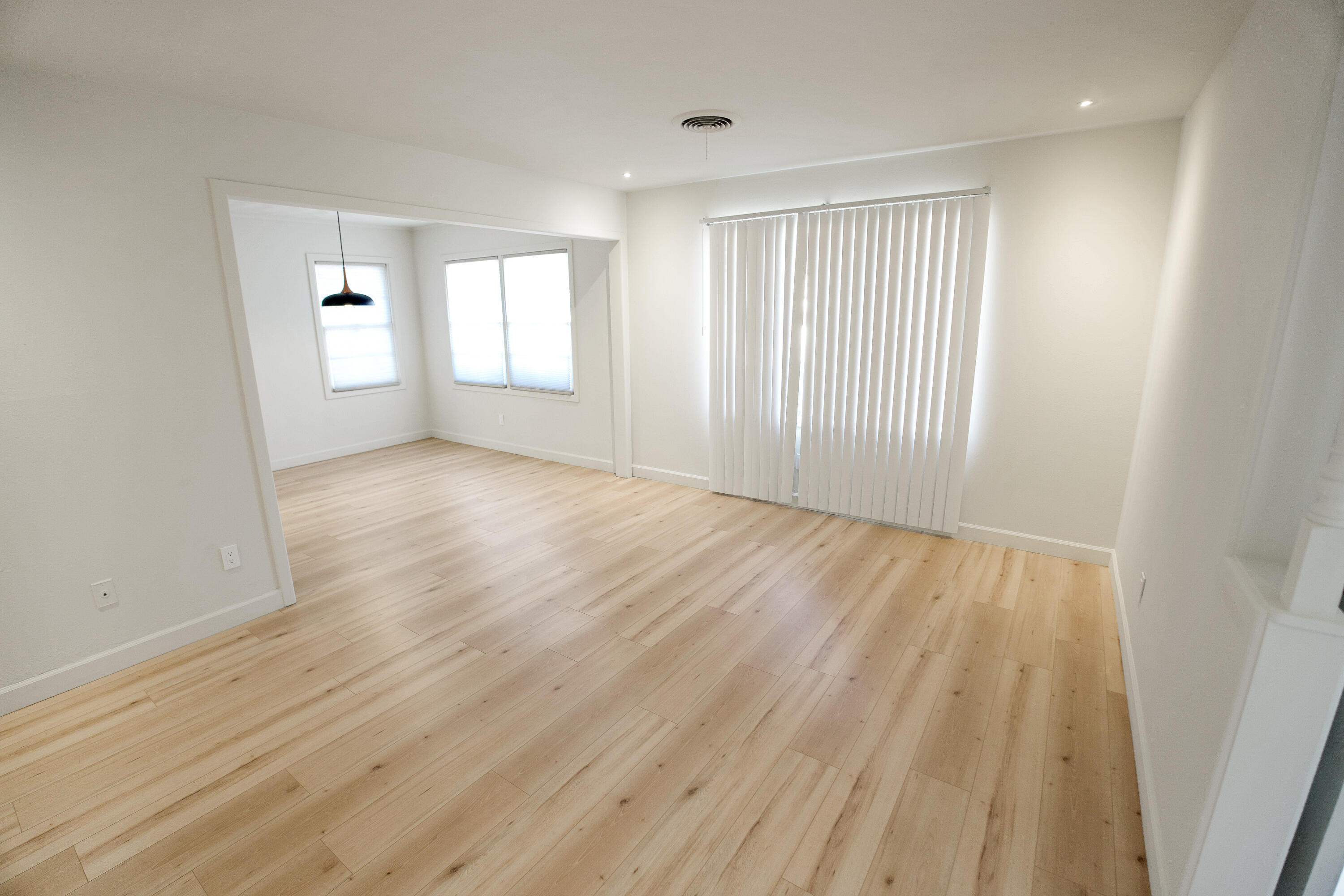 3827 52nd Street Lubbock, TX 79413 - Photo 9 of 24 wooden floor in an empty room with a window