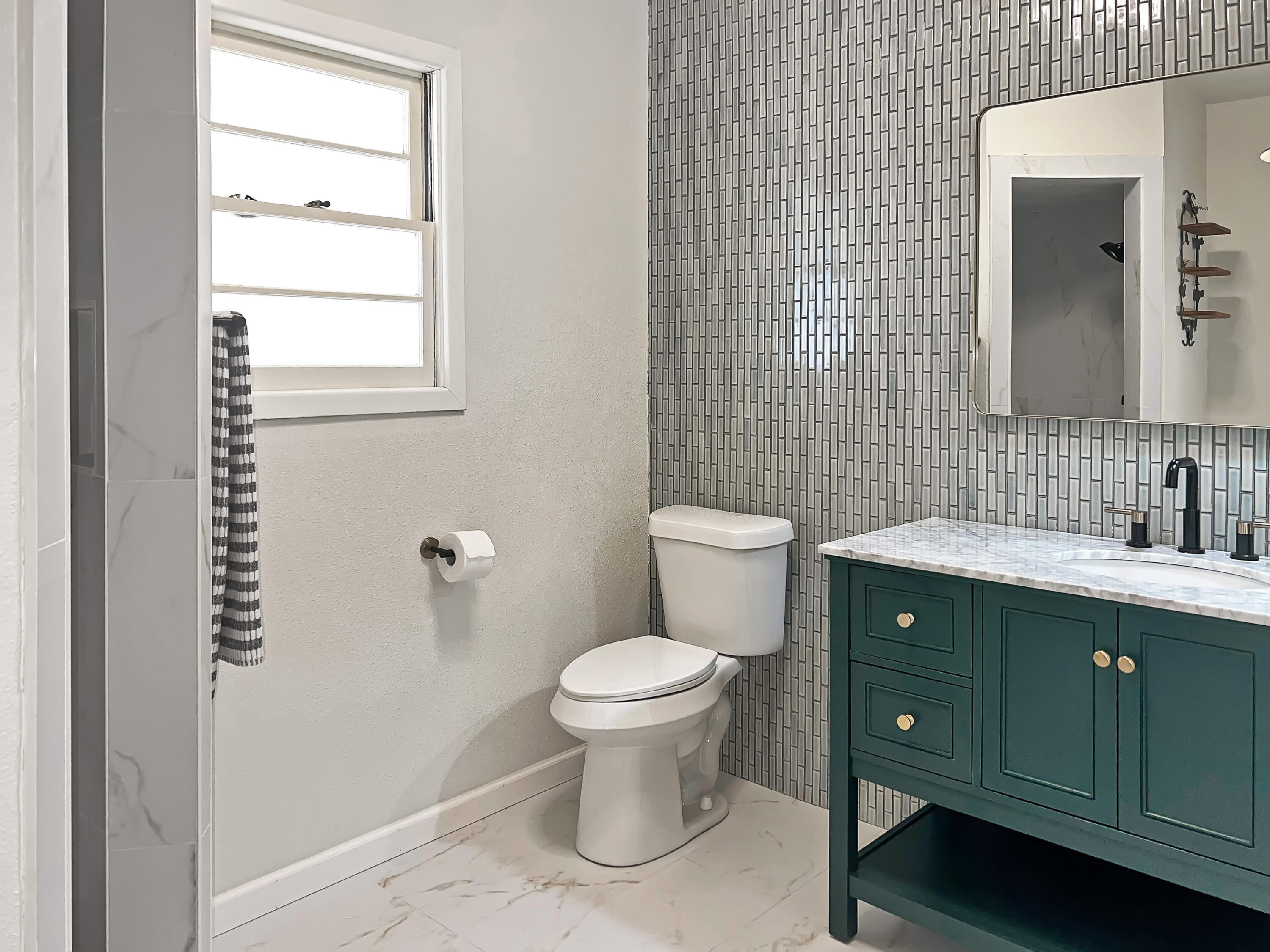 3827 52nd Street Lubbock, TX 79413 - Photo 10 of 24 a bathroom with a toilet sink and mirror