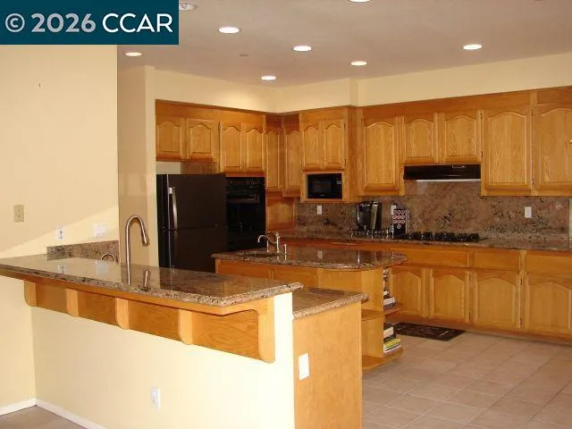 a kitchen with granite countertop a sink cabinets and window