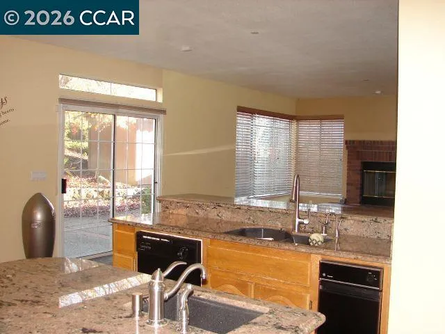 a view of living room with furniture and a fireplace