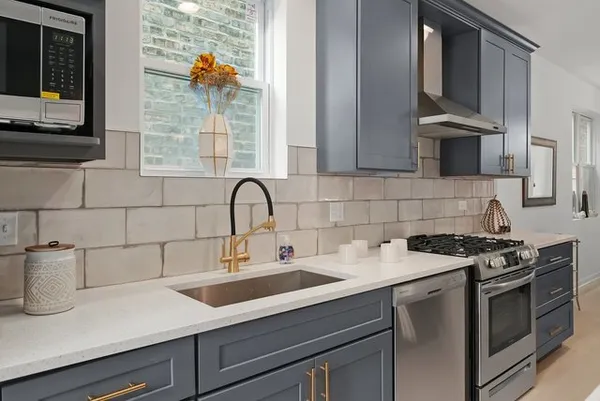 a kitchen with a sink stove and cabinets