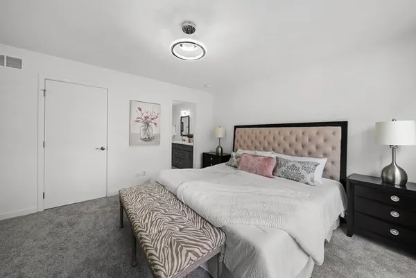 a bedroom with a bed and a lamp