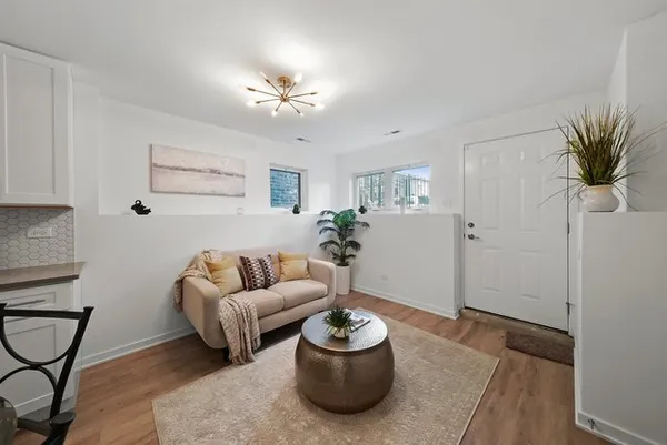 a living room with furniture and a potted plant