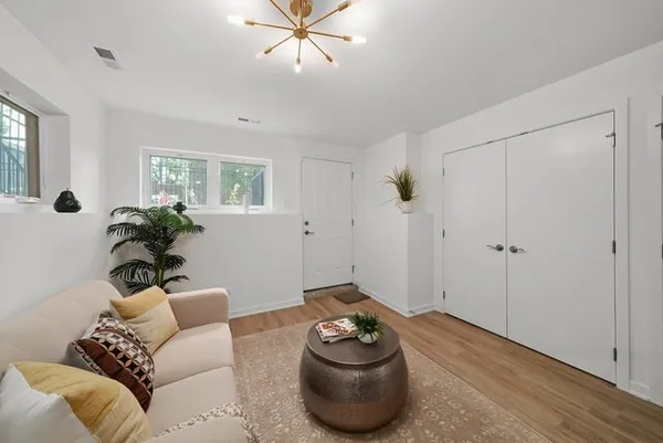 a living room with furniture and a potted plant