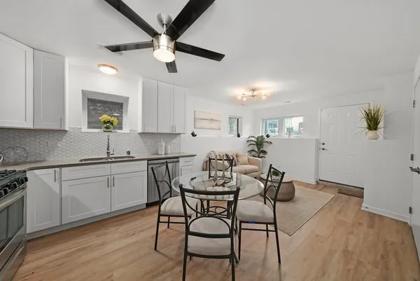 a view of a dining room with furniture and wooden floor