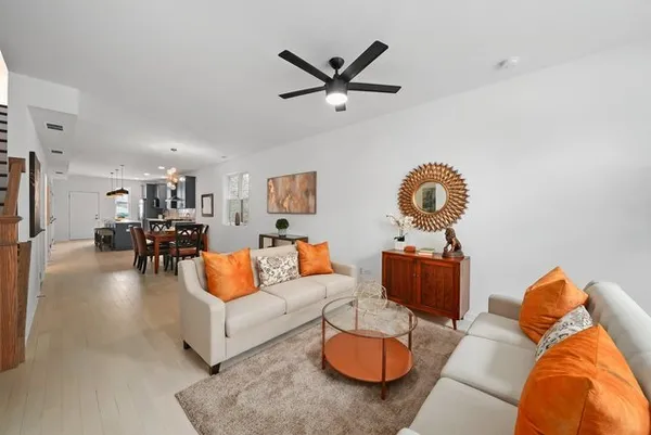 a living room with furniture and kitchen view