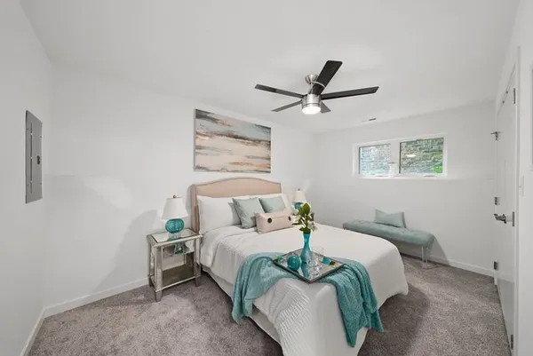 a bedroom with a bed and a chandelier