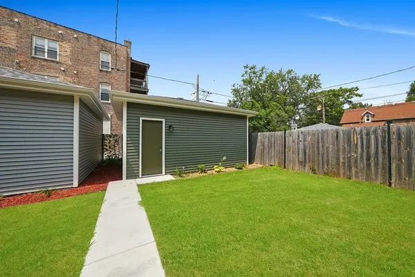a front view of a house with yard and green space