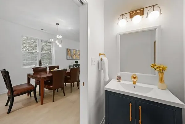 a view of a dining room with furniture and chandelier