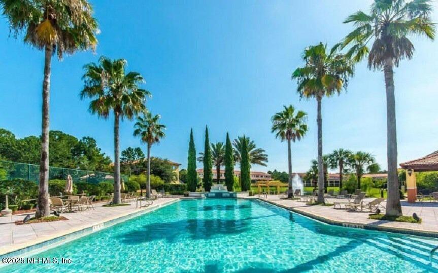 9745 Touchton Road, Unit 723 Jacksonville, FL 32246 - Photo 13 of 18 a view of a swimming pool with a garden