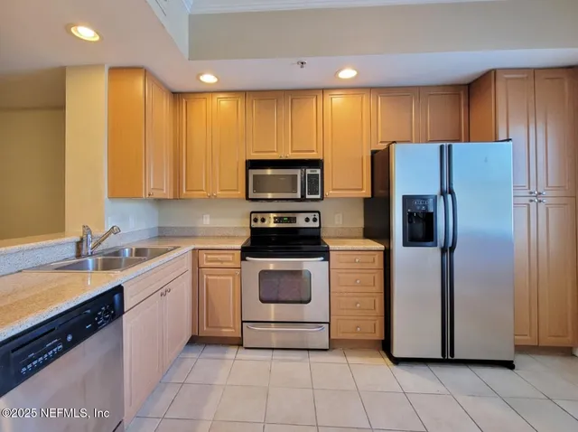 a kitchen with a refrigerator and a sink