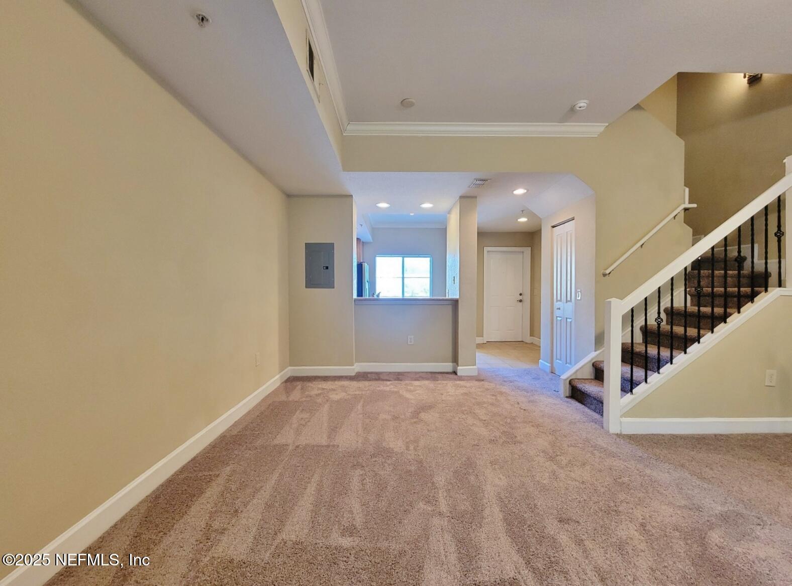 9745 Touchton Road, Unit 723 Jacksonville, FL 32246 - Photo 5 of 18 a view of an empty room with wooden floor and stairs