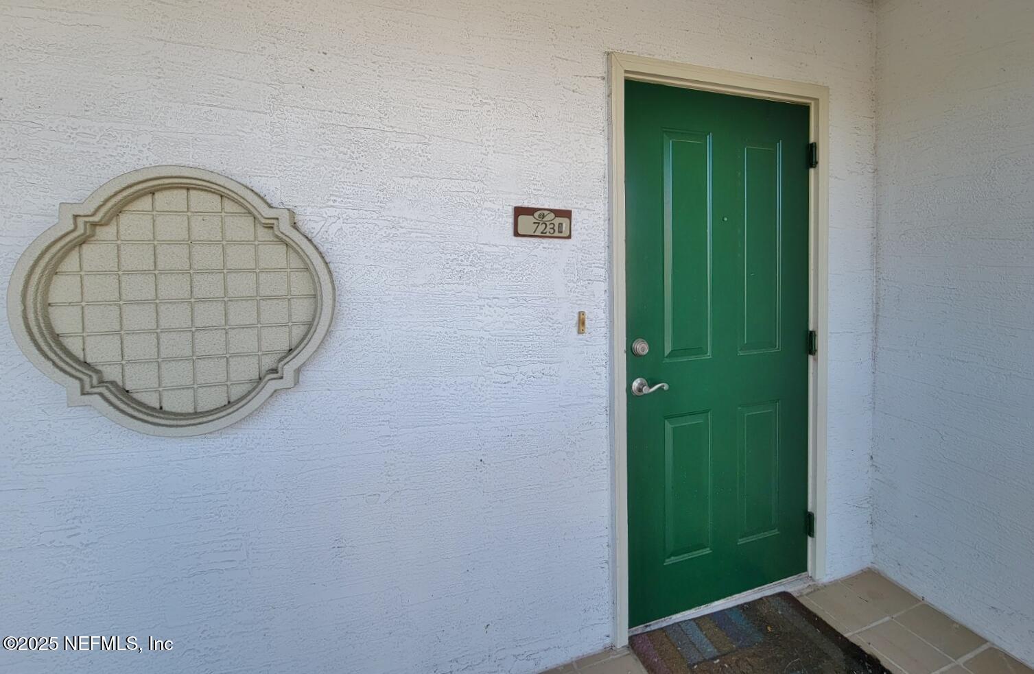 9745 Touchton Road, Unit 723 Jacksonville, FL 32246 - Photo 8 of 18 a view of a livingroom with a wooden door and a window