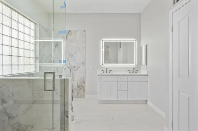 a bathroom with a bathtub and shower