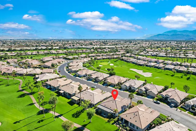 an aerial view of residential houses with outdoor space and street view
