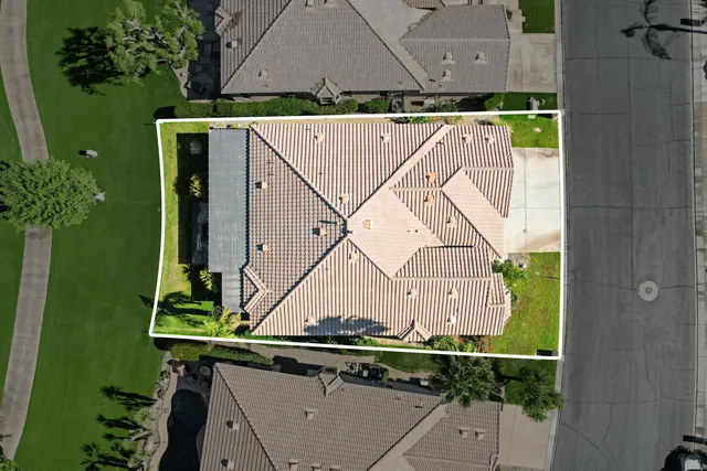 an aerial view of a house with a garden and trees