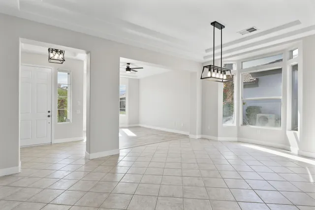 a kitchen with stainless steel appliances granite countertop a sink and white cabinets