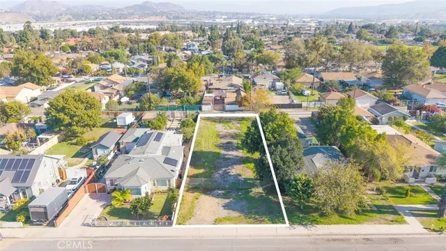 an aerial view of residential houses with city view