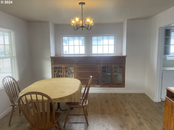 a view of a dining room with furniture and chandelier