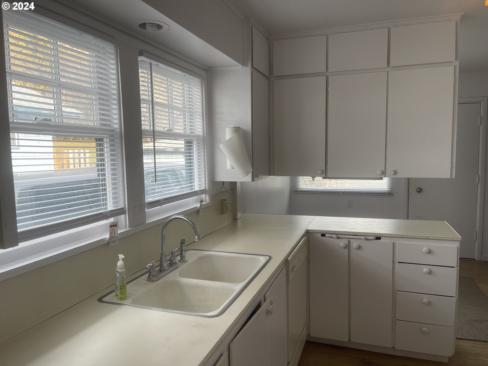 240 North Court Street Heppner, OR 97836 - Photo 5 of 19 a kitchen with a sink cabinets and window