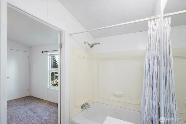 a bathroom with a shower and a glass door