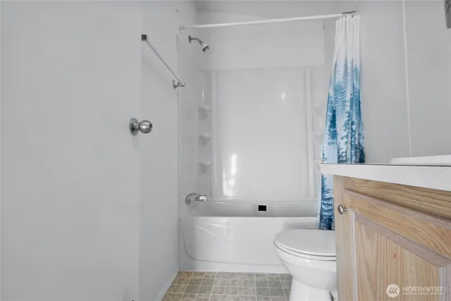 a bathroom with a toilet a sink and shower