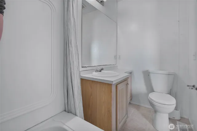 a bathroom with a sink a toilet and a mirror