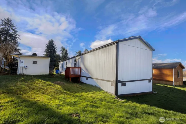 a backyard of a house with yard and garage