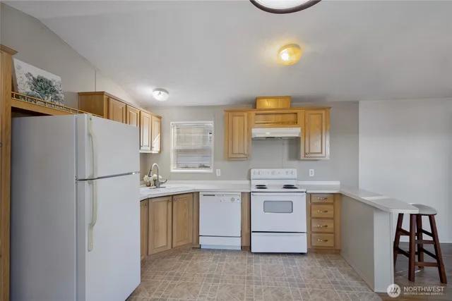 a kitchen with a stove a sink and a refrigerator