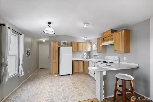 a kitchen with a sink appliances and cabinets