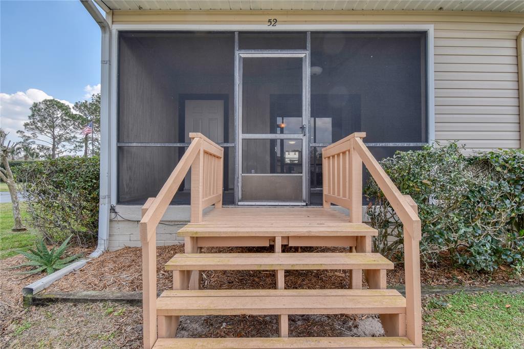 11001 Southeast Sunset Harbor Road, Unit H52 Summerfield, FL 34491 - Photo 1 of 31 a view of house with outdoor space and porch