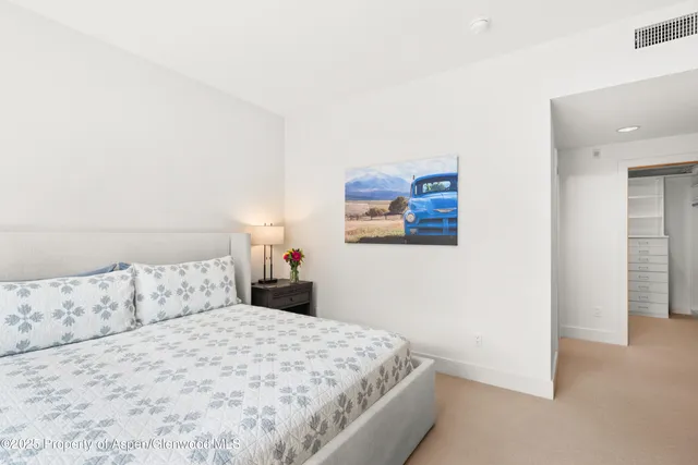 a bedroom with a bed and a painting