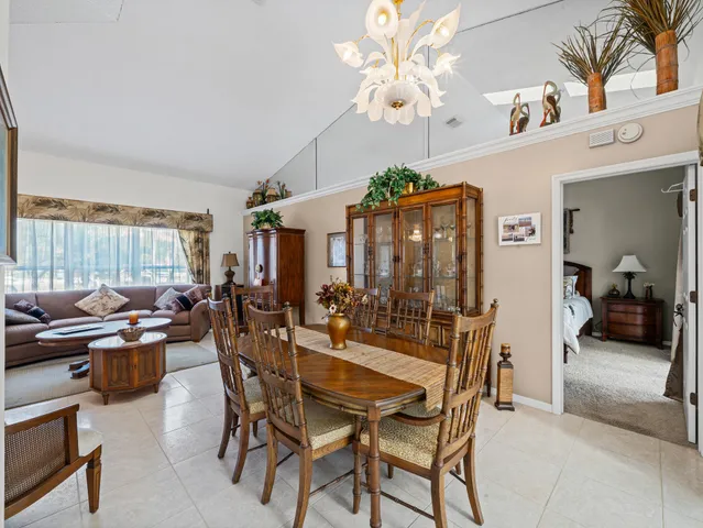 a bathroom with a granite countertop bathtub a sink and a mirror