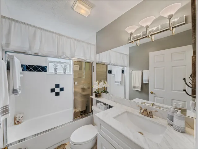 a backyard of a house with lots of green space and wooden fence