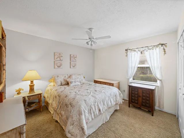 a view of a house with a yard and potted plants
